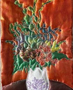 Orange blomma med broderi